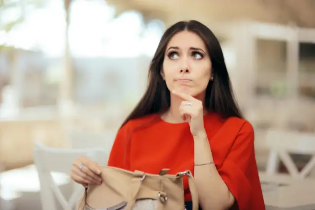 woman thinking of items in her purse