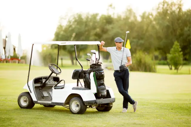 a golfer and a golf cart